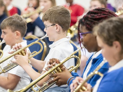 A group of young musicians playing brass instruments
