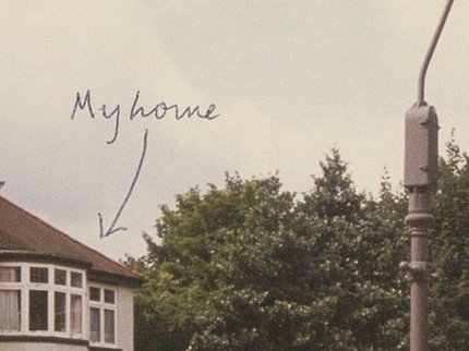 A photo of a semi detached house with handwriting My House and an arrow pointing at the house.