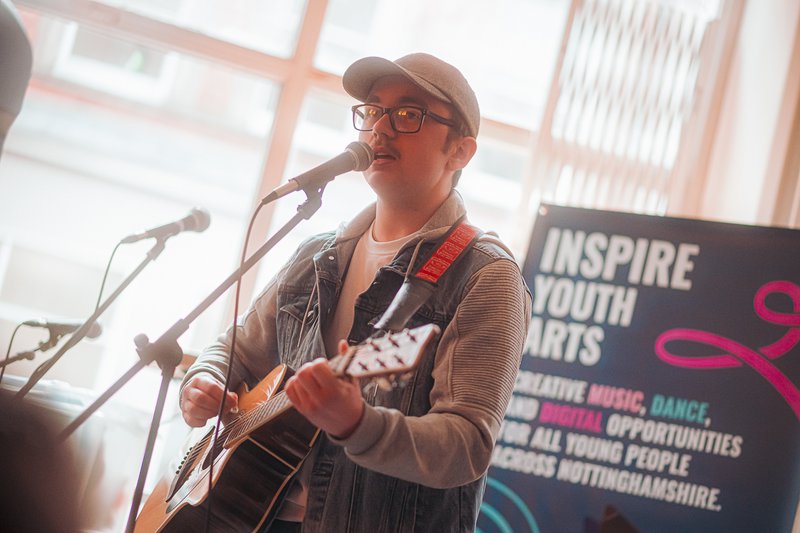 A man playing guitar and singing