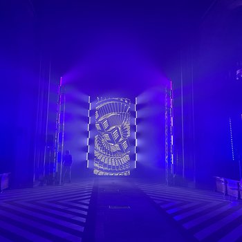 An empty church with purple lights and a black and white screen