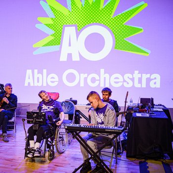 Able Orchestra members on stage performing