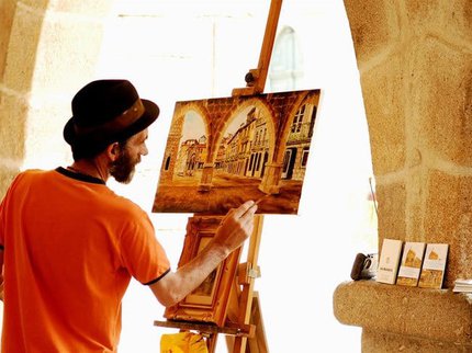 A painting of a man painting at an easel of a historical street