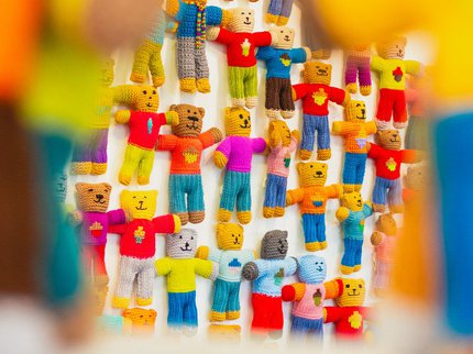 A wall of knitted bears in all different colours
