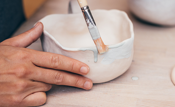 Small clay pot is being painted
