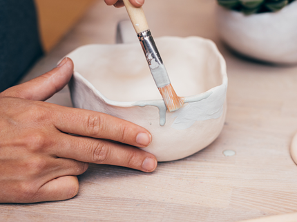 Small clay pot is being painted