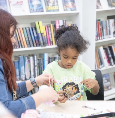 Child using recycled items to craft