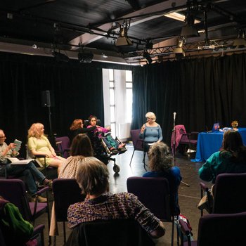 Photo of a circle of writers at the Neville Studios
