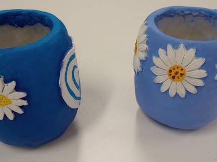 Blue clay vases with daisy pattern