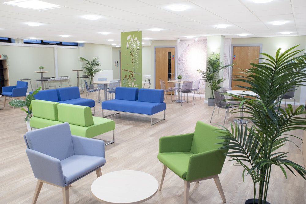 Mansfield cafe area with seating and tables in blue and green.
