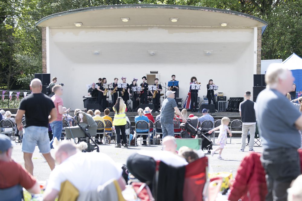 A group of musicians on stage with a crowd outside