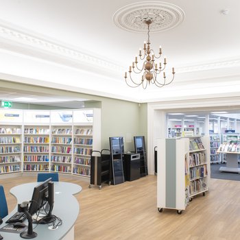The interior of Retford Library featuring bookshelves and a chandelier