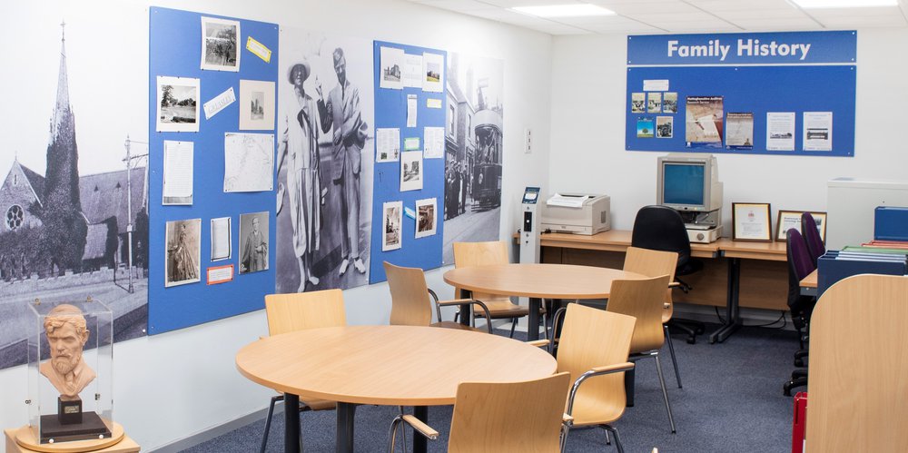 Internal view of Eastwood Library, showing a display of photographs related to D H Lawrence and the Family History area