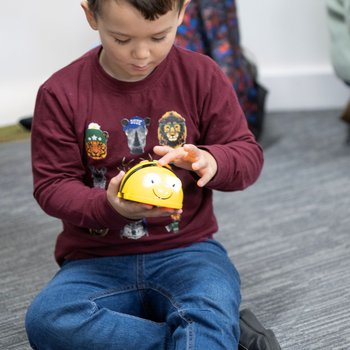boy playing with Bee-Bot
