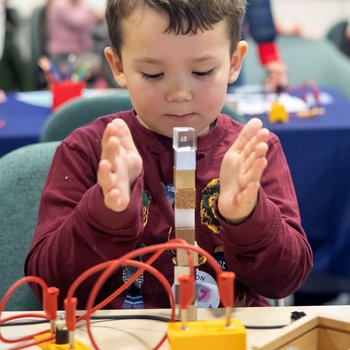 Young boy balancing cubes
