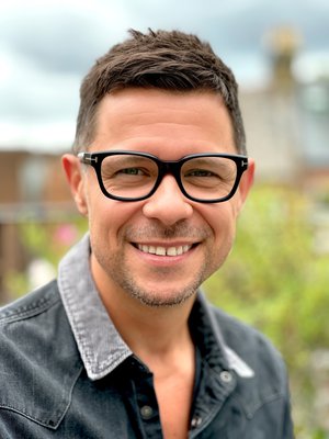 Photo of author Guy Bass, a white man with short dark brown hair and glasses.