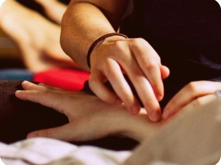 Hands using pressure points on wrist of someone else
