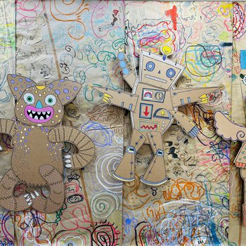 A close up of the large cardboard puppets, with brown paper decorated with colourful scribbles in the backfround