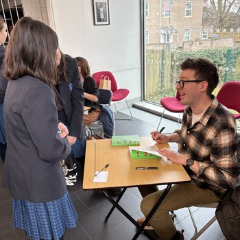 Author Simon James Green signs a book