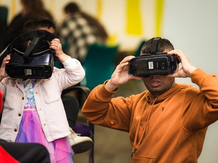 A couple of visitors wearing virtual reality headsets.