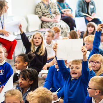 Children holding up artwork