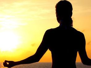 silhouette of lady meditating