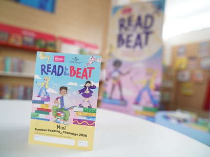 Mini Challenge Collector card in foreground with Read to the Beat Banner blurred in background