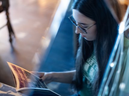 A mirror image of a girl reading