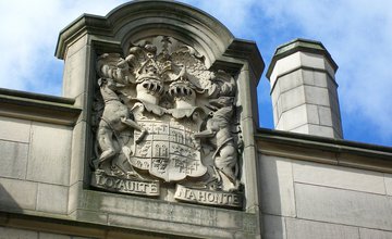 Stone work at the top of a building with a family coat of arms