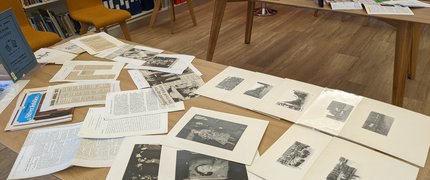 old local history photos and text spread on a table