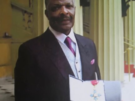 Pastor Weaver showing his medal