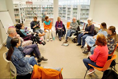 Photograph of poets from the Social Model Writers performing