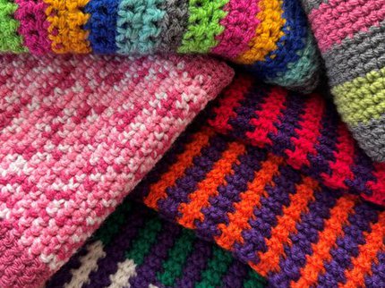 A pile of colourful scarves