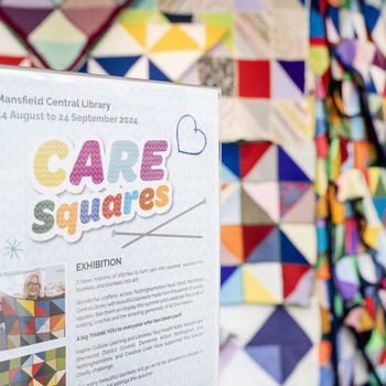 Wall of knitted brave bears in many colours with acorn motif on their tshirts