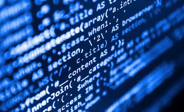 Black computer screen with blue coding text