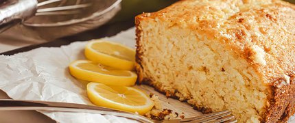 Lemon cake on a plate with slices of lemon