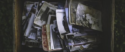 old photographs in a wooden crate