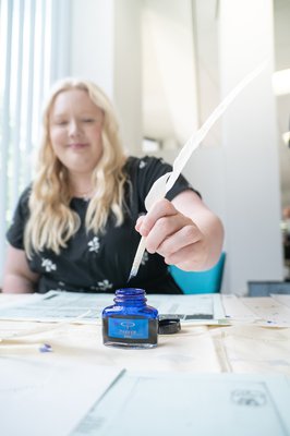 Woman writing with a quill pen