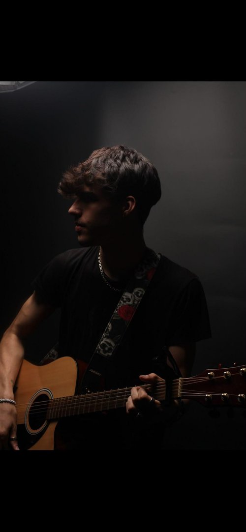 A person singing with a guitar.