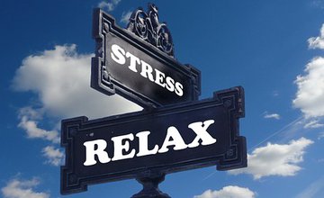 Post with direction signs saying stress and relax